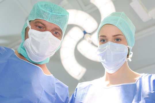 two surgeons working on patient