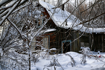 Typical russian abandoned snow-covered village in winter day
