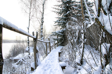 Typical russian abandoned snow-covered village in winter day