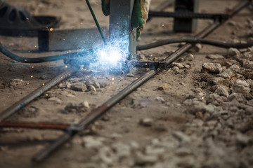 Worker welds metal at the construction site