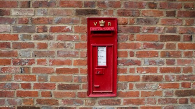 Victorian red letterbox in brick wall