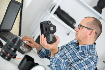 technician examining and repairing dslr camera