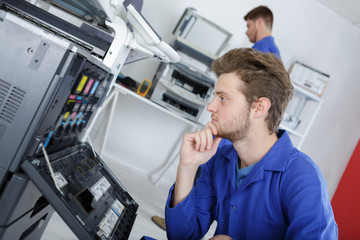 Fototapeta premium modern printing machine operator checking machine