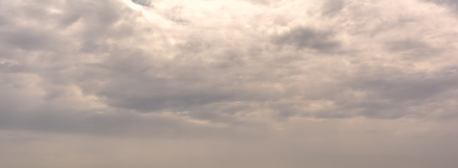 Dramatic sky background. Background of pastel clouds. Horizontal cloudscape photography. Texture of soft colored dramatic cloudy sky.