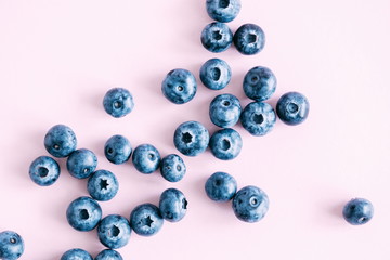 Berry background. Fresh berry blueberries on a pink background. Concept of healthy and dieting eating. Flat lay, top view, copy space 