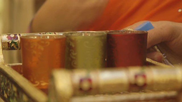 Indian marriage ceremony colourful golden try with rose water