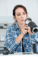 female photographer looking at zoom lens