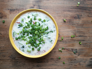 Okroshka on kvass in a yellow plate