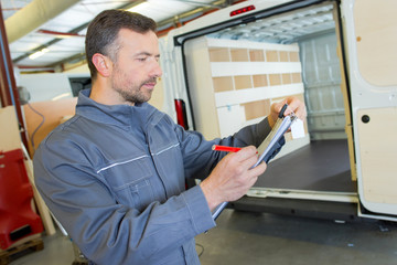 Fototapeta premium warehouse worker reading the report