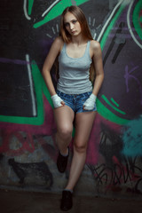 Fototapeta premium Portrait of a beautiful fighter girl under the bridge.