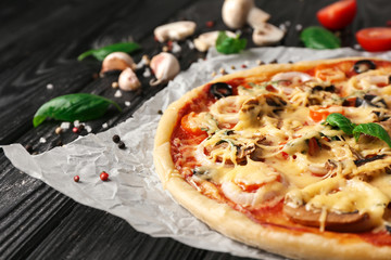 Tasty pizza on wooden table, closeup