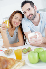 Obraz na płótnie Canvas a happy couple eats breakfast together