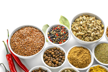 Bowls with various spices on white background