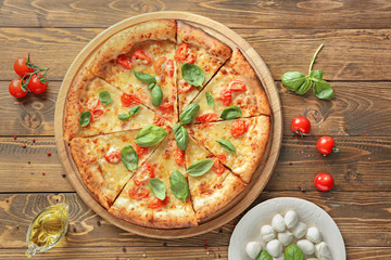 Delicious pizza Margherita and mozzarella cheese on wooden background