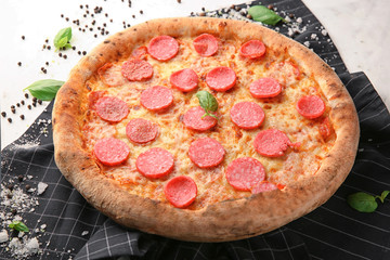 Delicious pizza with salami on table