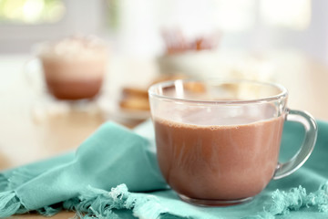 Obraz na płótnie Canvas Cup with hot cocoa drink on table