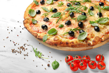 Board with delicious pizza on wooden background, closeup