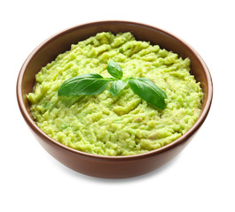 Bowl with tasty guacamole on white background