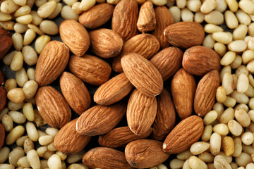 Tasty fresh almonds and pine nuts, closeup