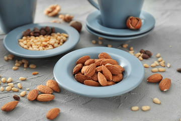 Plate with almonds on textured background