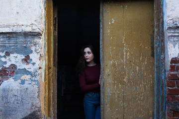 Fototapeta na wymiar dark-haired girl on a gloomy background