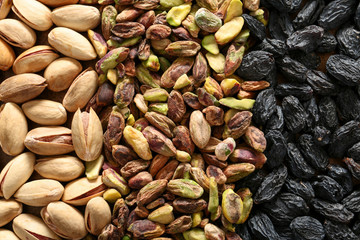 Pistachio nuts with dark raisins, closeup