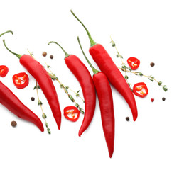 Composition with chili peppers, herbs and spices on white background