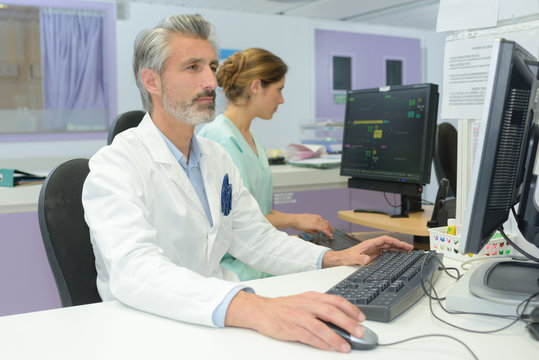 Senior medical worker using computer