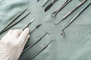 Dentist with set of tools on fabric