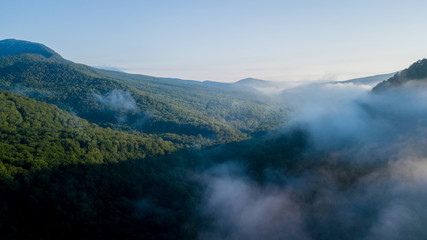 Epic Aerial Flight Through Mountain Clouds. Sunrise Beautiful Morning.