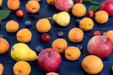 Fresh fruits on blue wooden background.