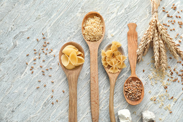 Fototapeta na wymiar Composition with wheat flour, grains and pasta on wooden background