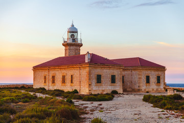 Punta Nati Lighthouse at Menorca Island, Spain, on a beautiful sunset