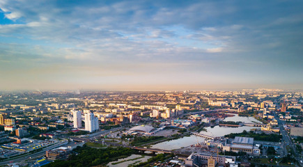 Fototapeta na wymiar Aerial drone panoramic view of Chelyabinsk city and embankment of Miass river, smoking pipes on the background and blurred horizon, city with bad ecological situation, Russia