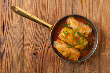 Traditional stuffed cabbage with minced meat and rice, served in a tomato sauce.