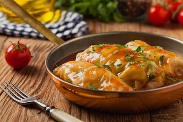 Traditional stuffed cabbage with minced meat and rice, served in a tomato sauce.