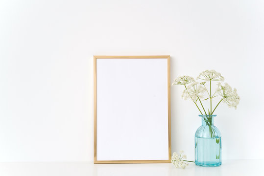 Gold frame mock up with a wild host in blue vase. Mockup for , promotion, design. Template for small businesses,bloggers