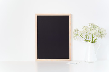 Chalk board mock up with a Aegopodium in jug. Mockup for promotion, design. Template for small businesses, bloggers