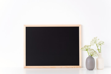 Chalk board mock up with a host in vases. Mockup for headline, design. Template for businesses,...