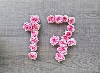 17, seventeen - vintage number of pink roses on the background of dark wood - for congratulations, postcards, websites, design, printing