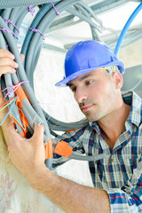 Builder holding cables taped together