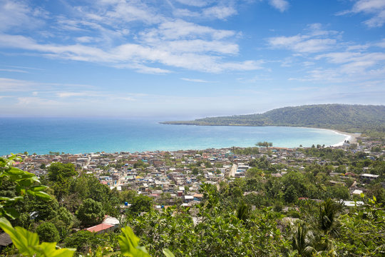 Panorama of the city of Baracoa, encompassing lush green vegetation and stunning ocean shoreline views, Cuba.