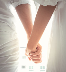 Close up of loving couple holding hands