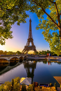 View of Eiffel Tower and river Seine at sunrise in Paris, France. Eiffel Tower is one of the most iconic landmarks of Paris
