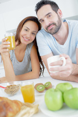Couple eating fresh fruit for breakfast