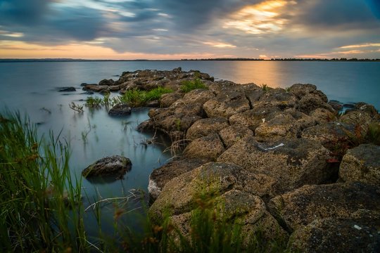 Sunset over a stone pier in Lake Colac in Victoria, Australia