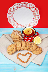 Composition of biscuits, cup of tea, nuts and lemon on the vintage background. Love concept.