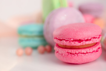 Tasty colorful macaron on white table, closeup
