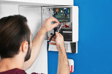 Electrician installing alarm system