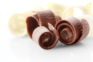 Delicious chocolate curls on white background, closeup